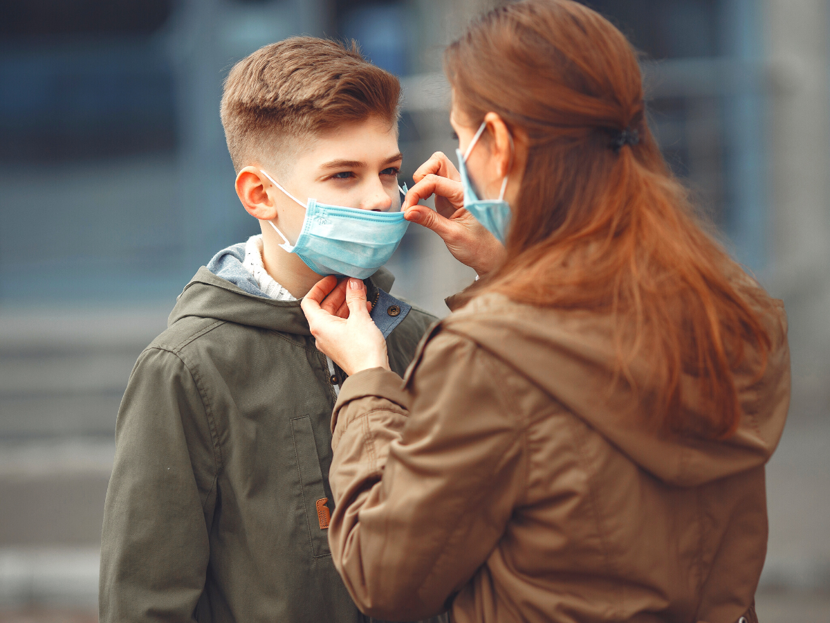 homeless man on street waiting for vaccine